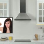 cucina con cappa tradizionale e ragazza con il pollice rivolto verso il basso